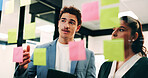 Man, woman and tablet with notes on glass wall in office, strategy or review at finance agency. Business people, broker and team with tech, solution and insight on app at asset management company