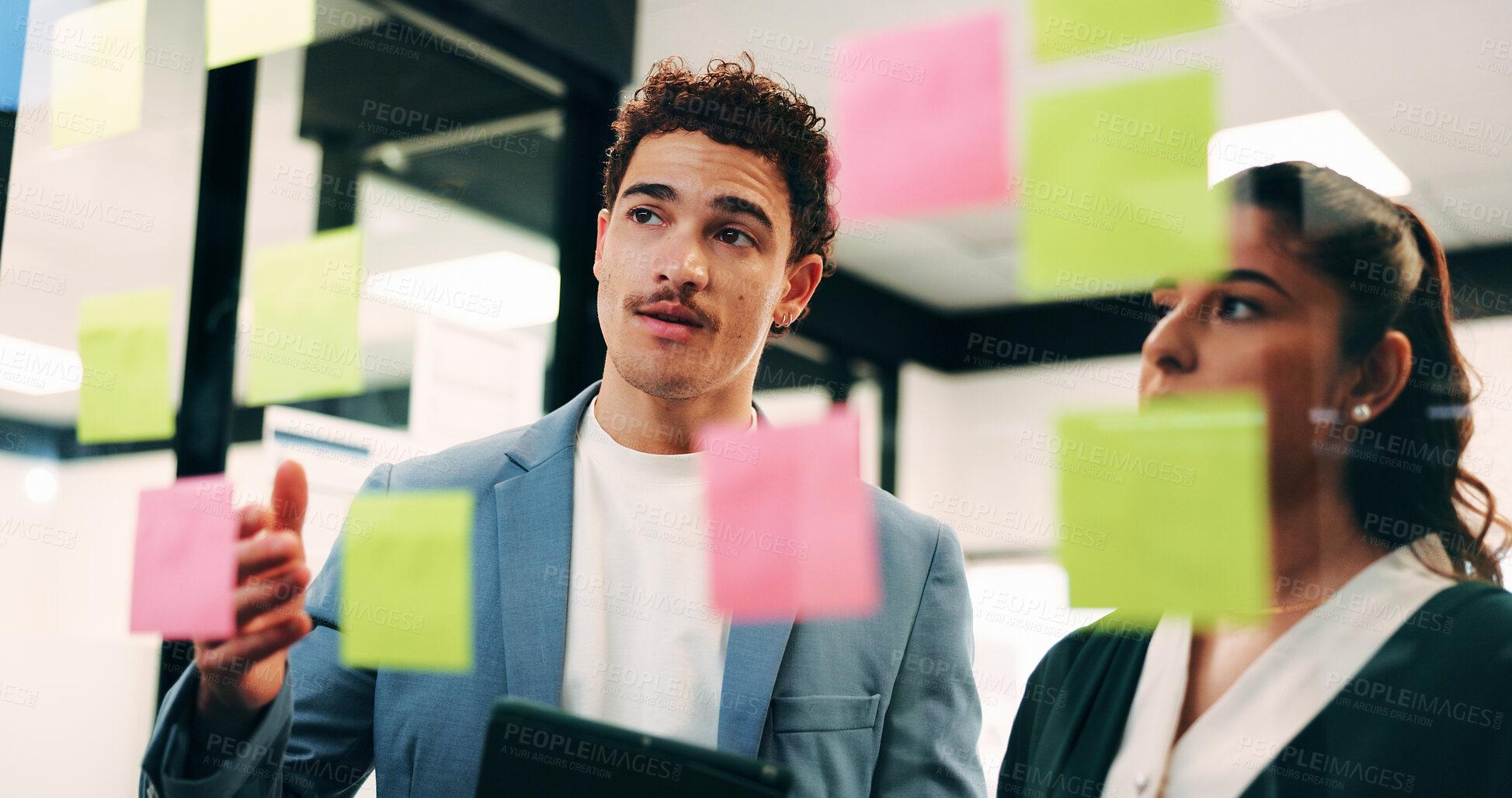 Buy stock photo Man, woman and tablet with notes on glass wall in office, strategy or review at finance agency. Business people, broker and team with tech, solution and insight on app at asset management company