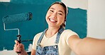Happy woman, selfie and painting wall with roller, renovation and property development at house. Asian person, interior design and remodeling in portrait, social media and post for home improvement