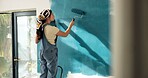 Painting, wall and back of woman in home for decoration, interior design and creative project. House, ladder and person with color, paintbrush and inspiration for remodeling, diy upgrade and change