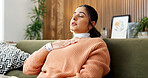 Woman, relax and breathe in home for meditation, spiritual healing and zen with holistic balance. Person, yoga and eyes closed on sofa with chakra, inner peace and inhale technique for mindfulness