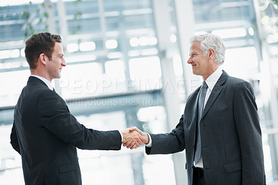 Buy stock photo Handshake, smile and business men with welcome, greeting and partnership with real estate agreement. Shaking hands, introduction and happy people in office with property investment, deal or meeting