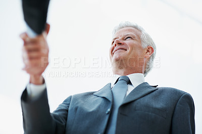Buy stock photo Below, handshake and meeting with business man in office for agreement, deal or welcome. Corporate, thank you and well done with mature executive shaking hands in professional workplace for contract