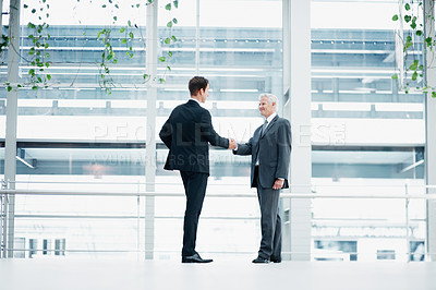 Buy stock photo Businessmen, deal or partnership with handshake for hiring or corporate meeting together in office. Male people, employees or colleagues shaking hands with introduction for recruiting or agreement
