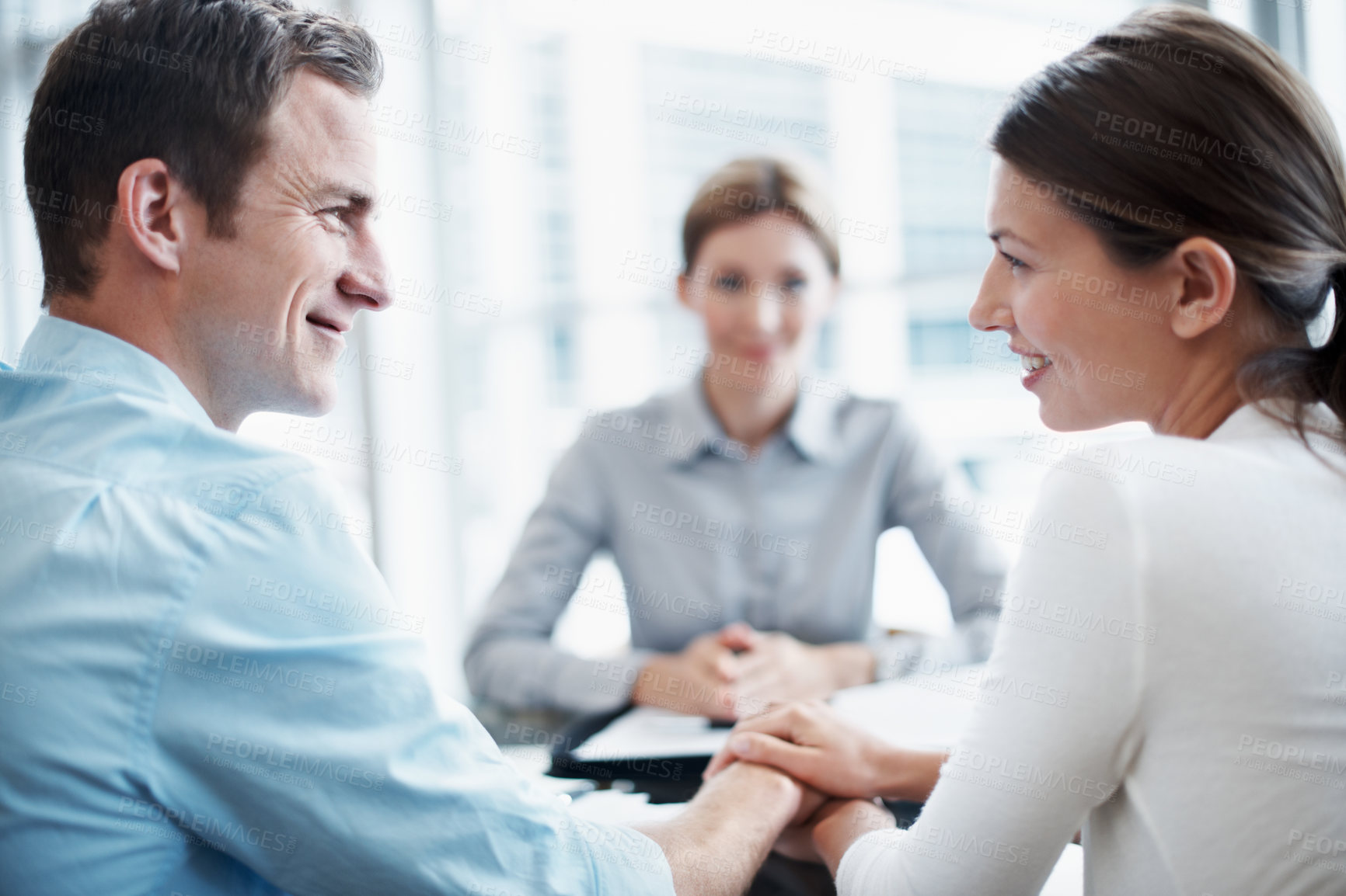 Buy stock photo Love, couple and financial advisor in office, holding hands and smile for asset management. Happy man, woman and investment consultant with clients for support, future security and budget review