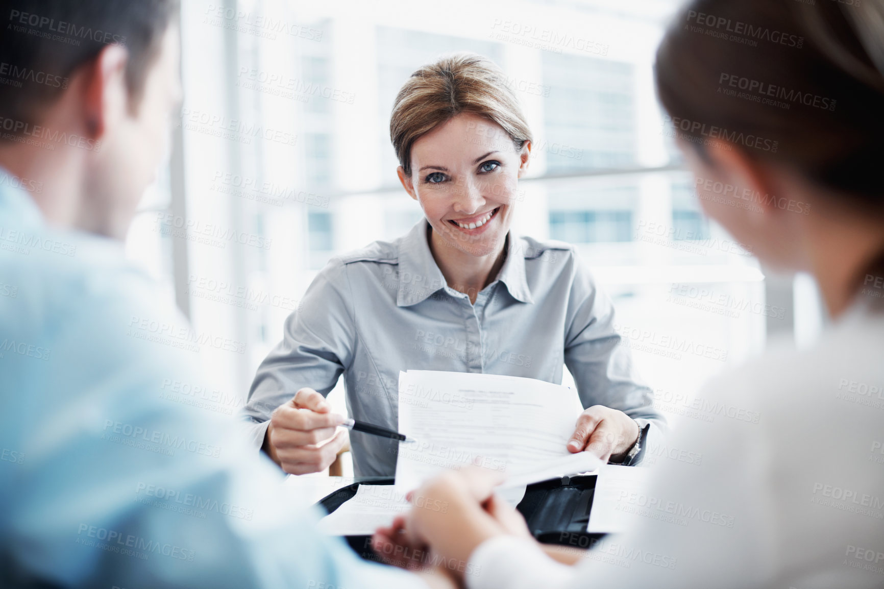 Buy stock photo Contract, couple and insurance advisor, holding hands or smile with application for financial policy. Man, woman and consultation with clients, documents or coverage benefits with portrait in office