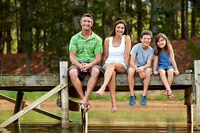 Buy stock photo Family, portrait and relax on dock for vacation with love, bonding and smile in nature together. Happy mother, father and children with pier outdoor for holiday, summer trip and travel with lake