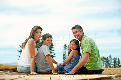 Buy stock photo Family, portrait and happy on pier for vacation with countryside, bonding and relax in nature together. Mother, father and children with dock outdoor for holiday, summer trip and travel with smile