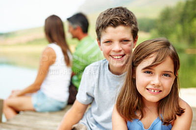 Buy stock photo Family, vacation and happy kids on lake dock, portrait and relax outdoor for summer travel. Siblings, children and break at pier on holiday together, tourism and chill with parents by water in nature