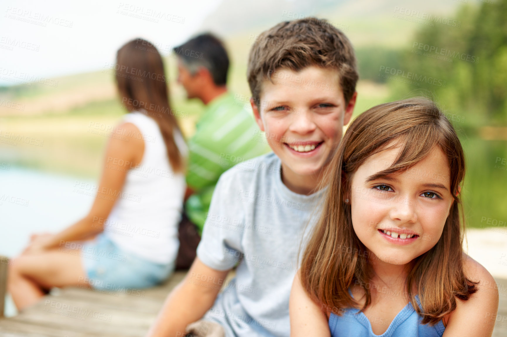 Buy stock photo Family, vacation and happy kids on lake dock, portrait and relax outdoor for summer travel. Siblings, children and break at pier on holiday together, tourism and chill with parents by water in nature