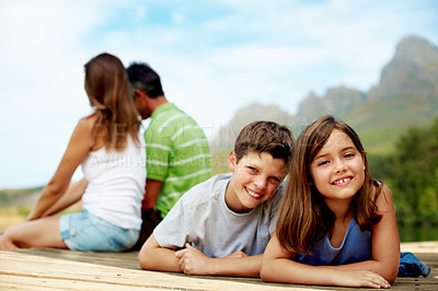 Buy stock photo Family, vacation and happy kids at dock, portrait and relax outdoor for summer travel with care. Siblings, children and break at pier on holiday together, tourism and love with parents in nature