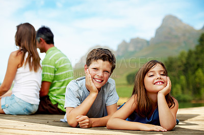 Buy stock photo Family, vacation and happy kids at pier, portrait and relax outdoor for summer travel with care. Siblings, children and break at dock on holiday together, tourism and love with parents in nature