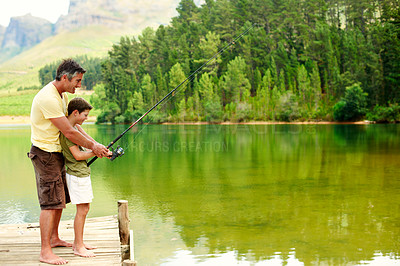 Buy stock photo Family, bonding and fishing with teenager, lake and dad with son on holiday and connection in nature. Outdoor, hobby and happy man with rod to catch fish in water, space and advice for boy and lesson