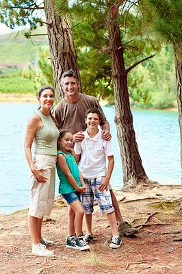 Buy stock photo Family, smile and portrait in forest for holiday with love, bonding and relax by lake together. Mother, father and children with people in woods for vacation, summer trip and travel in wilderness