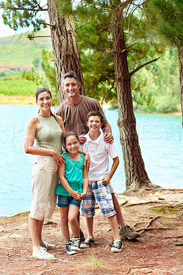 Buy stock photo Family, smile and portrait in woods for holiday with love, bonding and relax by lake together. Mother, father and children with people in forest for vacation, summer trip and travel in wilderness