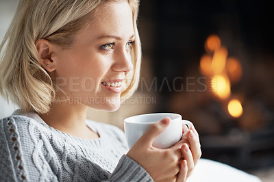 Buy stock photo A closeup shot of a young woman enjoying a cup of coffee indoors
