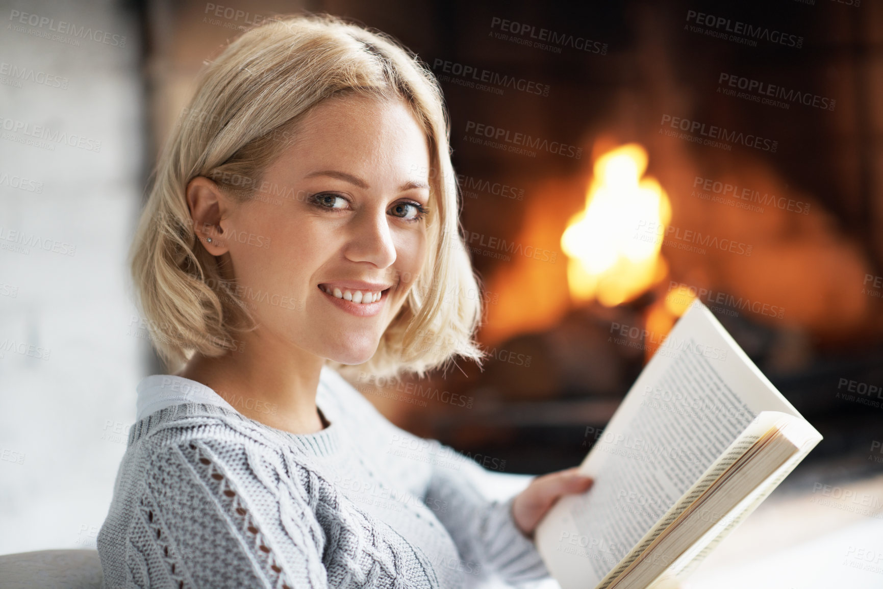 Buy stock photo Reading, book and portrait of woman in home with fire for comfort, hobby and relax with literature. Happy, fireplace and person with story or novel for information, knowledge and warmth on weekend