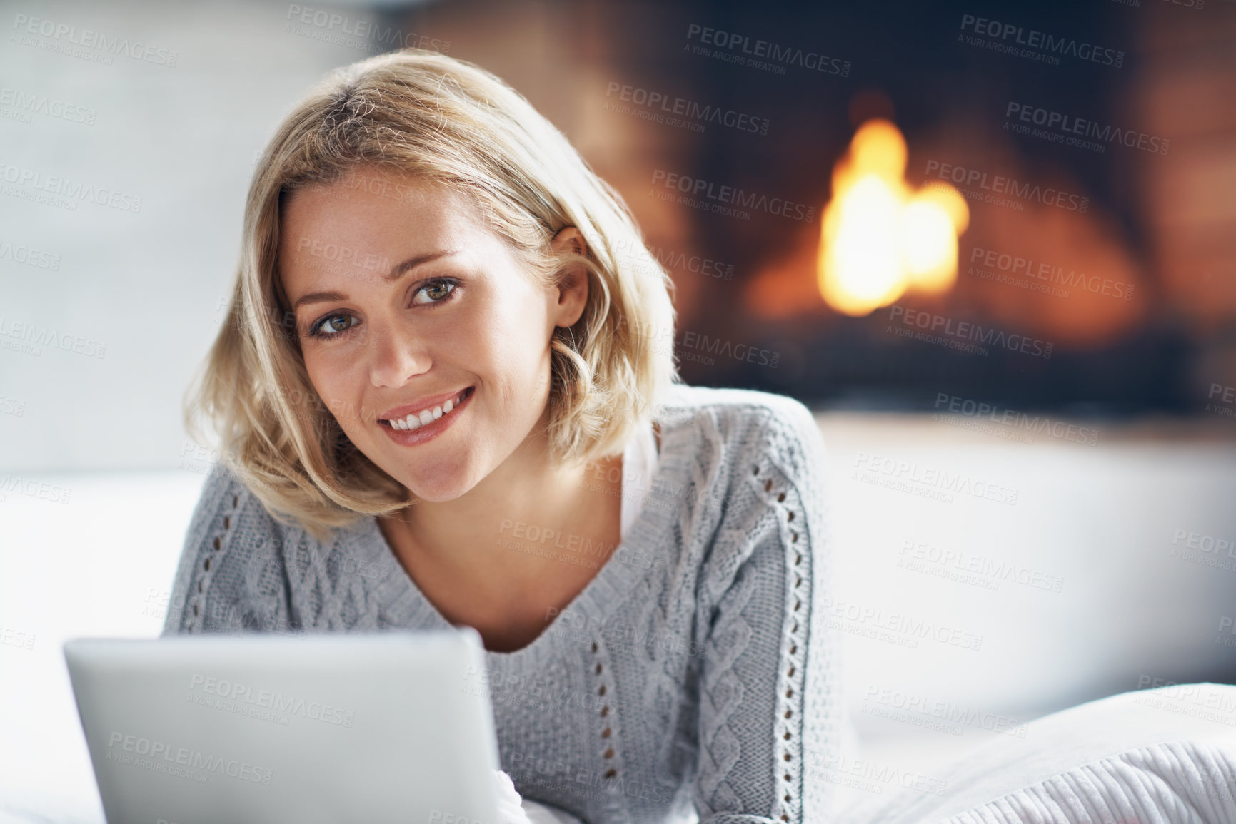 Buy stock photo Happy, tablet and portrait of woman by fireplace for internet, online subscription and relax. Home, smile and person on tech for connection, streaming series and rest with warmth for weekend break