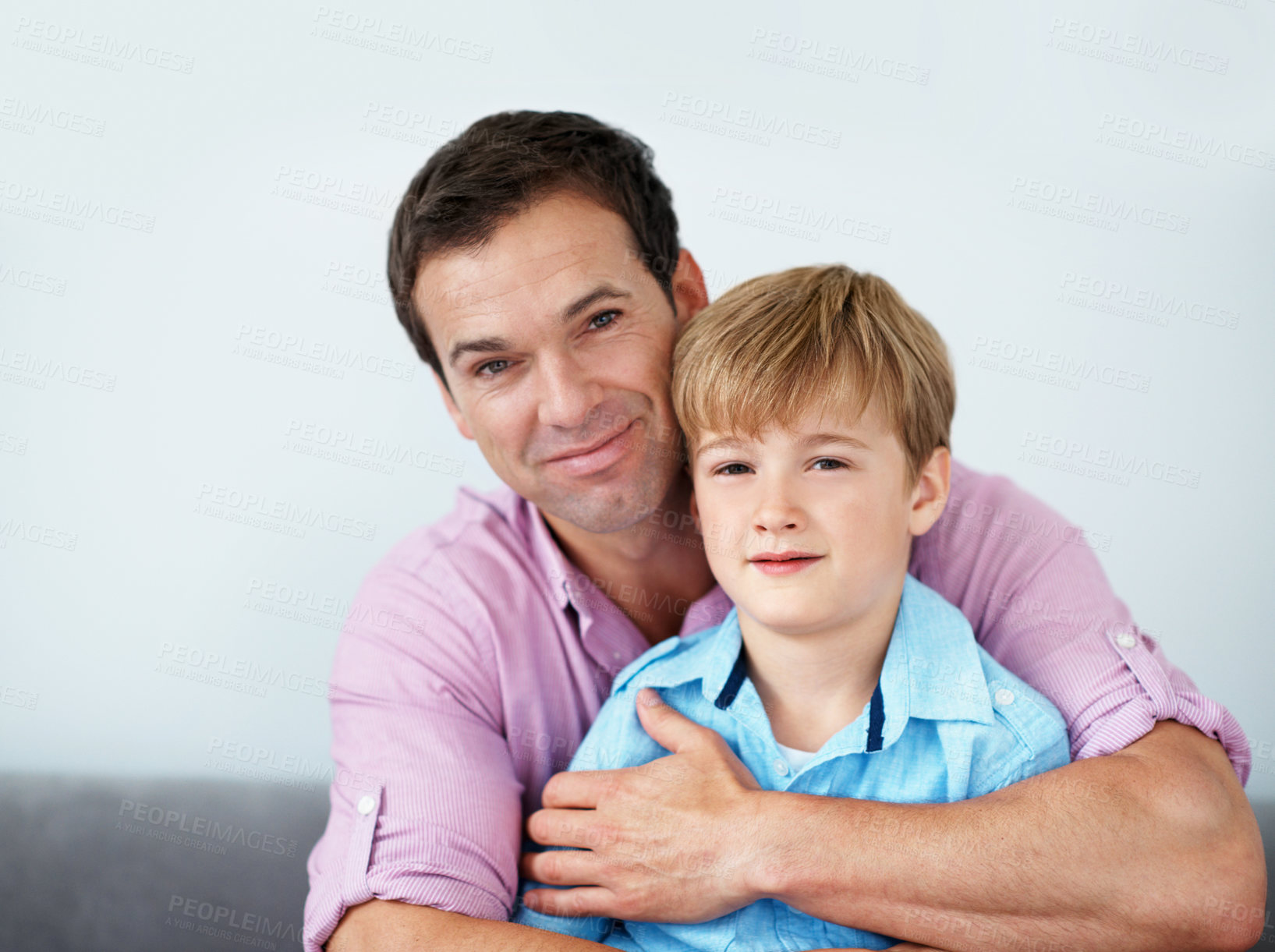 Buy stock photo Portrait, dad and child in living room with hug, family bonding together and proud of parenthood. Happy, man and son embrace in house with support, weekend break and appreciation on fathers day.