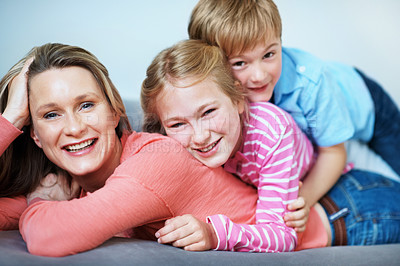 Buy stock photo Portrait, pile and mom with children in house, love and bonding with smile on weekend and connection. Family, stack and happy woman with kids, childcare and single parent with pride in Australia