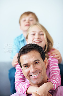 Buy stock photo Portrait, dad and kids in living room with hug, family bonding together and gratitude for papa in home. Happy, man and children embrace on sofa with support, connection or appreciation on fathers day