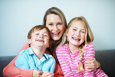 Buy stock photo Childcare, portrait  and mom with children in lounge, family and bonding with smile on break or love. Happy woman, home and affection for kids, embrace and single parent with pride in Australia