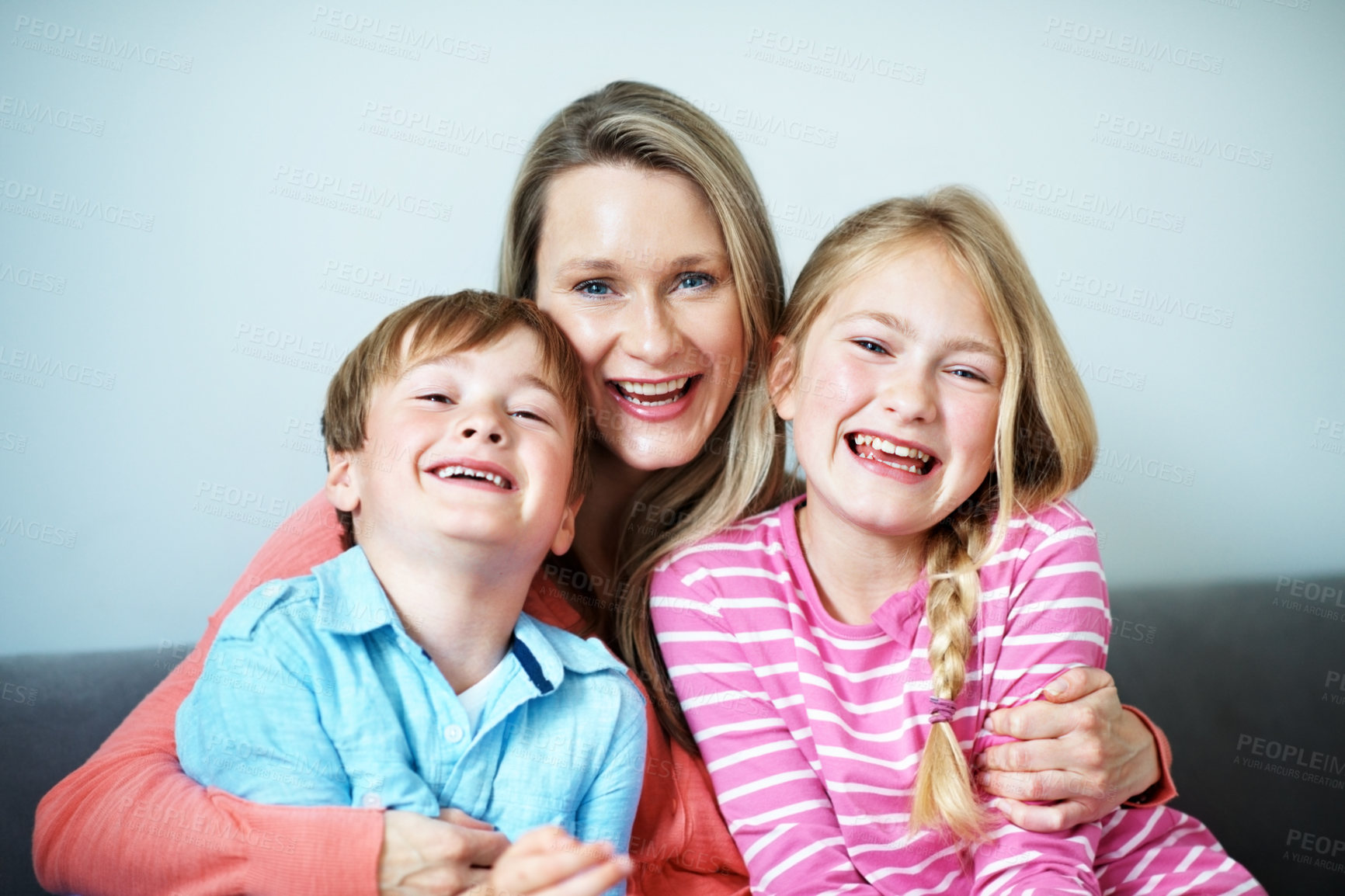 Buy stock photo Childcare, portrait  and mom with children in lounge, family and bonding with smile on break or love. Happy woman, home and affection for kids, embrace and single parent with pride in Australia