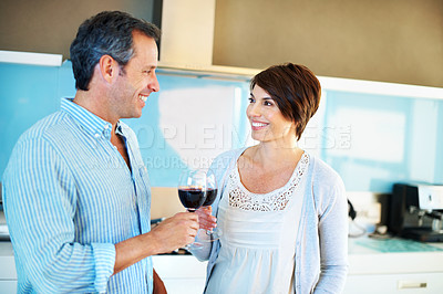 Buy stock photo Cheers, wine and couple in kitchen for love, relationship and bonding on anniversary weekend. Happy, home and man with woman with alcohol, drinks and toast for commitment, marriage and celebration