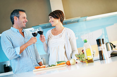 Buy stock photo Cooking, happy couple and toast with wine, celebration or bonding with partner on weekend in kitchen. Laughing, people and cheers with alcohol, anniversary and meal prep with ingredients in house