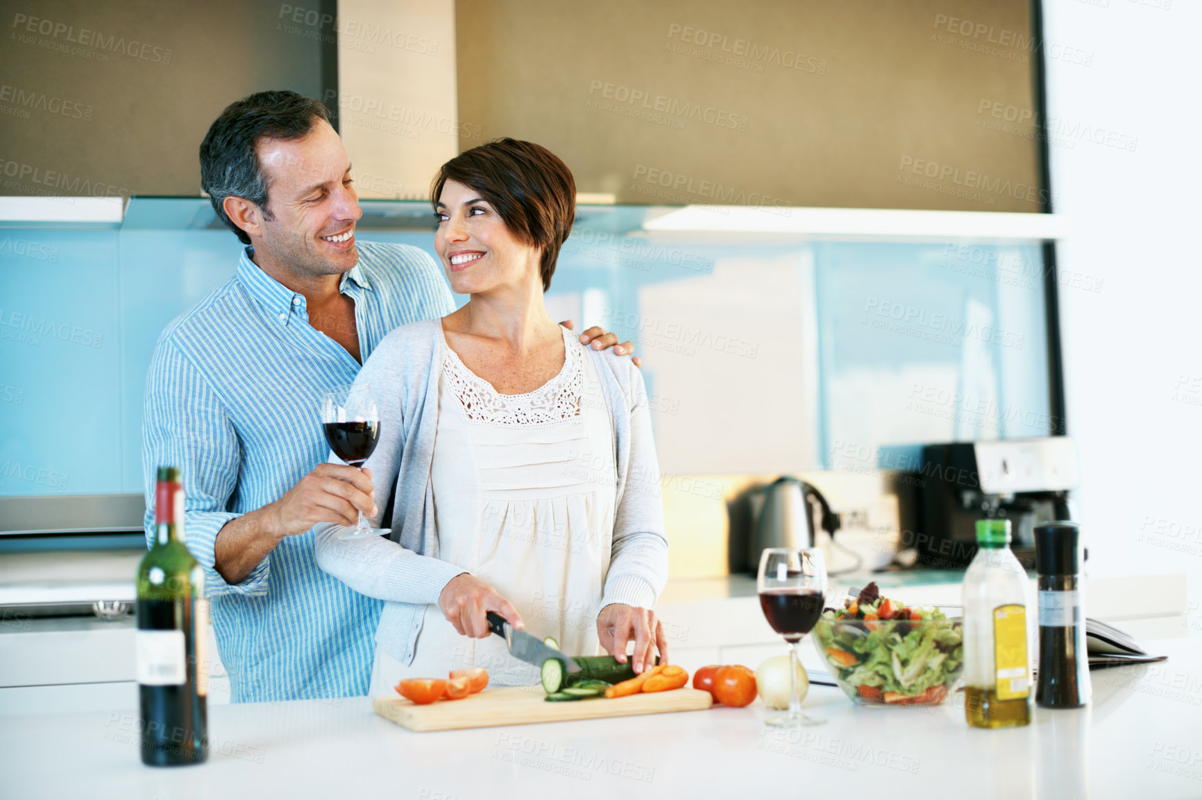 Buy stock photo Love, happy couple and cooking with red wine in home, organic food and slice vegetables. Mature man, woman and meal prep at kitchen with alcohol, healthy cucumber and vegetarian diet with care