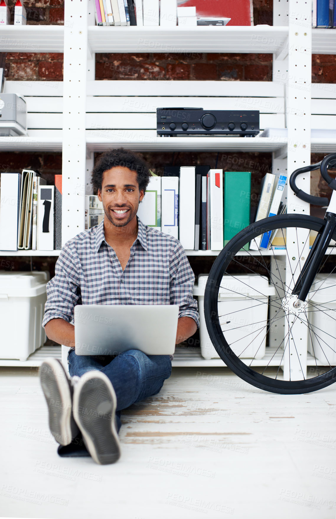 Buy stock photo Startup, portrait and black man on floor with laptop for copywriting, online article and story draft. Happy, bicycle and person on computer for research, website blog and report at creative agency