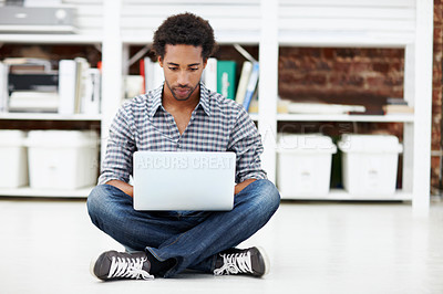 Buy stock photo Laptop, typing and black man on floor in office for copywriting, online article and story draft. Creative, startup and person on computer for research, website blog and digital report in workplace