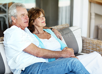 Buy stock photo Relax, morning and senior couple on patio for bonding, marriage and connection on weekend. Retirement, happy home and man with woman on couch for relationship, love and thinking together with embrace