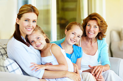 Buy stock photo Grandmother, mom and happy kids with care in home, relax or holding hands together for love. Grandparent, sisters and mother on sofa with support, children or generations with family portrait for hug