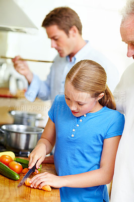 Buy stock photo Cooking, cutting and learning with child and grandfather in kitchen for help, lunch and food. Love, vegetables and teaching with old man and granddaughter in family home for wellness and support