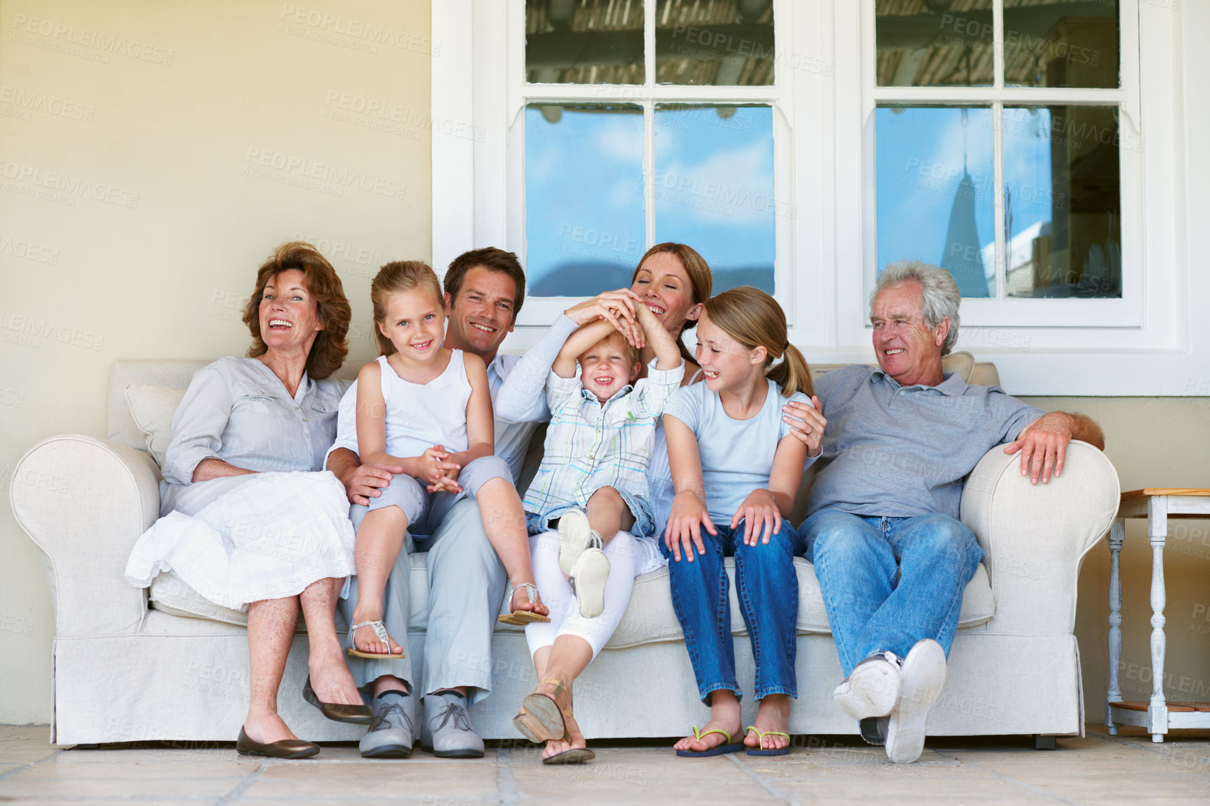 Buy stock photo Big family, laugh and children on couch, home and bonding with senior people on weekend or together. Happy, portrait and connection with kids on break, generations and parents with smile at house