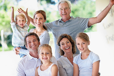Buy stock photo Portrait, big family and excited outdoor for bonding, love and care with generations on patio. Grandparents, parents and children with people on porch, cheering or relax together for trust and memory