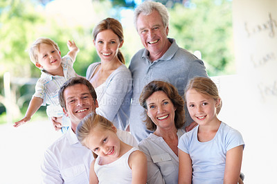 Buy stock photo Portrait, big family and happy outdoor for bonding, love and care with generations on patio. Grandparents, parents and children with people on porch, smile and relax together for trust and memory