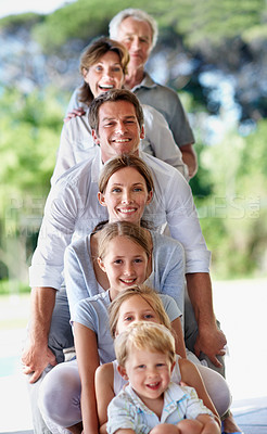 Buy stock photo Portrait, pile and family with children, home and bonding with senior parents on weekend or outdoor. Grandparents, together and connection with kids on break, generations and happy people stack