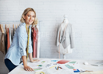 Buy stock photo A young designer designing clothes in her work space