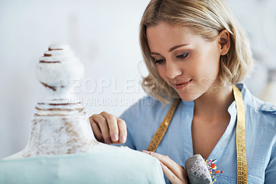 Buy stock photo A gorgeous young dressmaker working on her design on a mannequin
