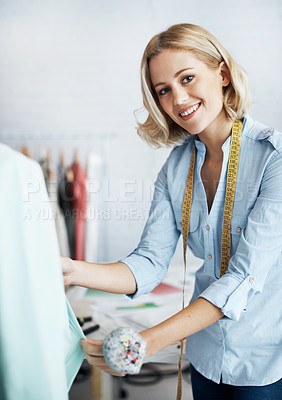 Buy stock photo A gorgeous young dressmaker working on her design on a mannequin
