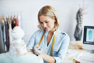 Buy stock photo A gorgeous young dressmaker working on her design on a mannequin