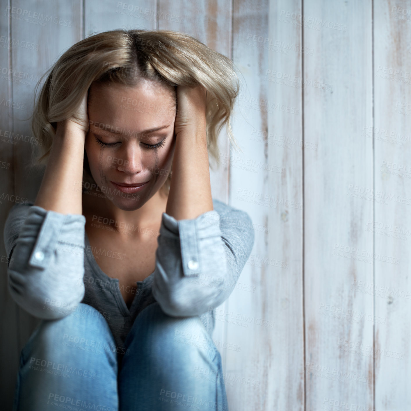 Buy stock photo Wooden wall, unhappy and woman with tears, crying and sad with anxiety and frustrated after mistake. Mental health, space and person with depression, grief and mourning with broken heart or regret