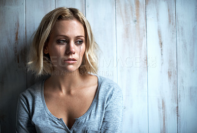 Buy stock photo A pretty young blonde woman with mascara tears running down her face
