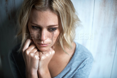Buy stock photo High-angle view of a young woman with mascara tears running down her face