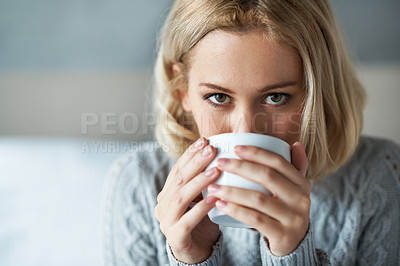 Buy stock photo Closeup portrait of a pretty young woman drinking a cup of coffee at home