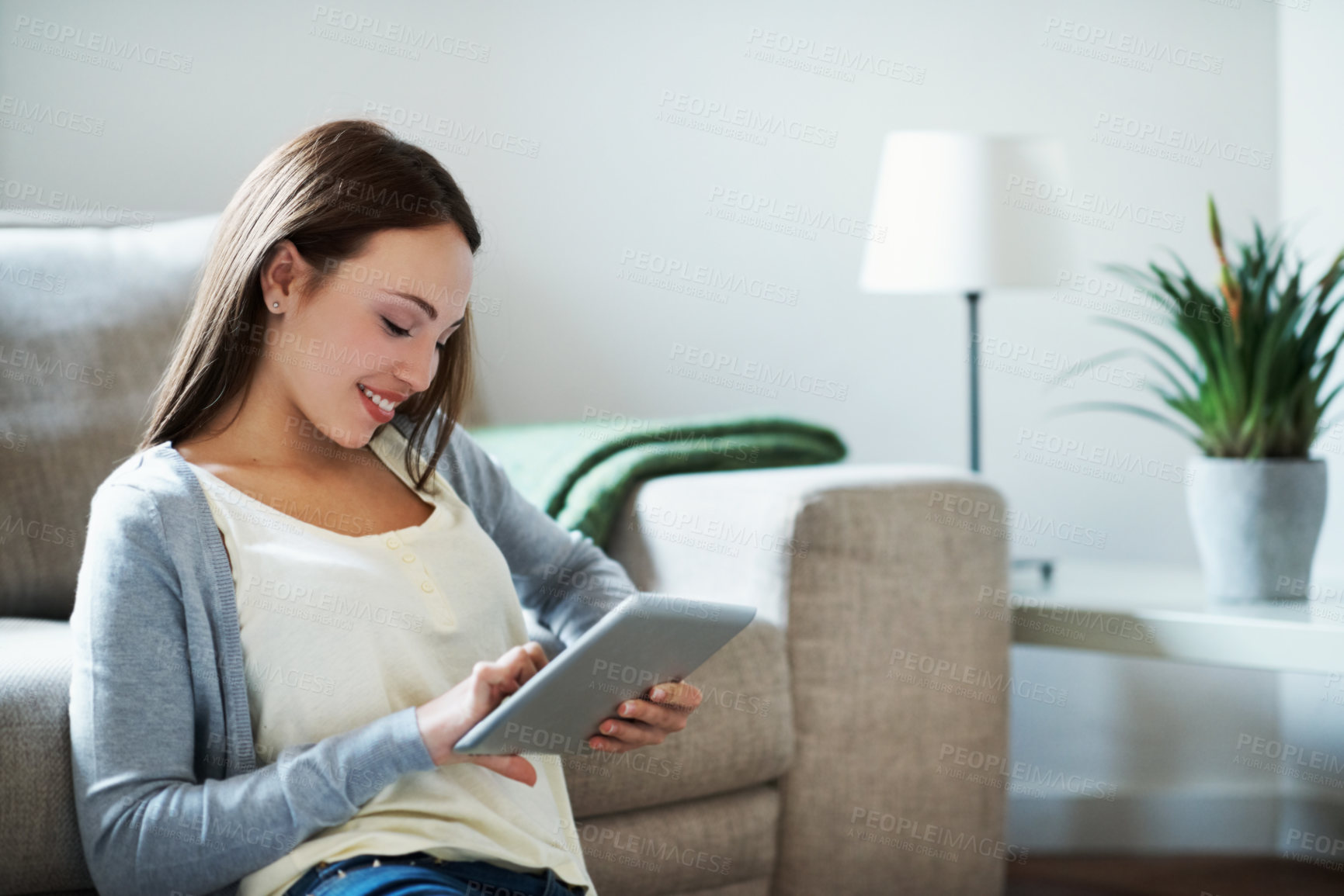 Buy stock photo Elearning, online and teen with tablet in home, happy and scroll research for assignment on website. Education, student and person with smile, knowledge and studying info with technology in house