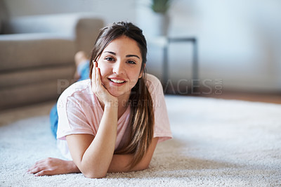 Buy stock photo Portrait of a young teenage girl lying on the living room floor 
