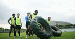 Training, coach and people with tire on field, strength challenge and workout for sport competition. Space, trainer or rugby team with fitness exercise for muscle development, active or weightlifting